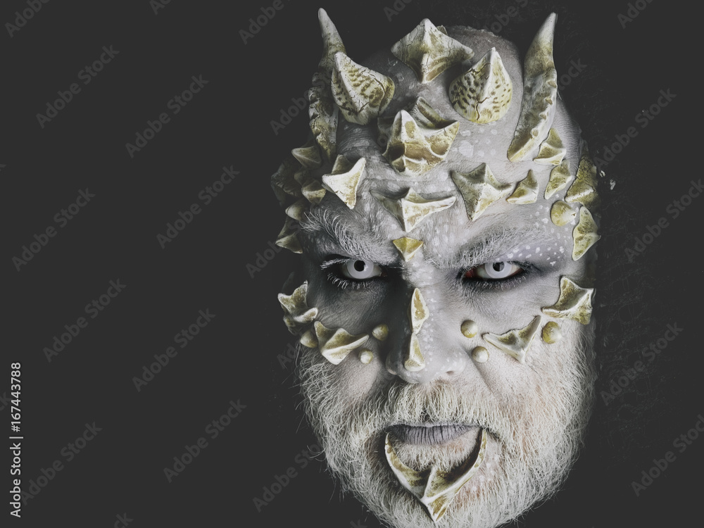 Fototapeta premium man or monster with thorns on face with futuristic makeup