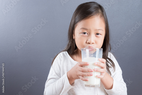 Asian kid cute girl happy to drink milk