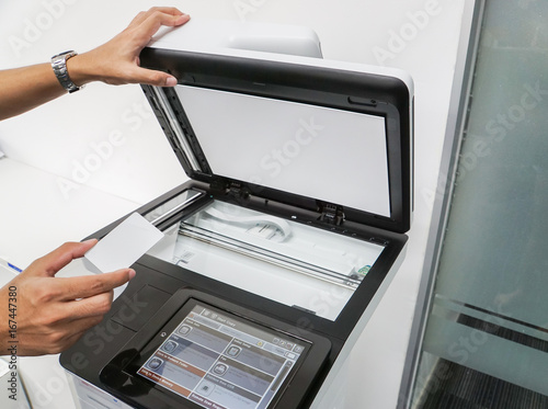 close up businessman hold smart card for scanning and printing documents