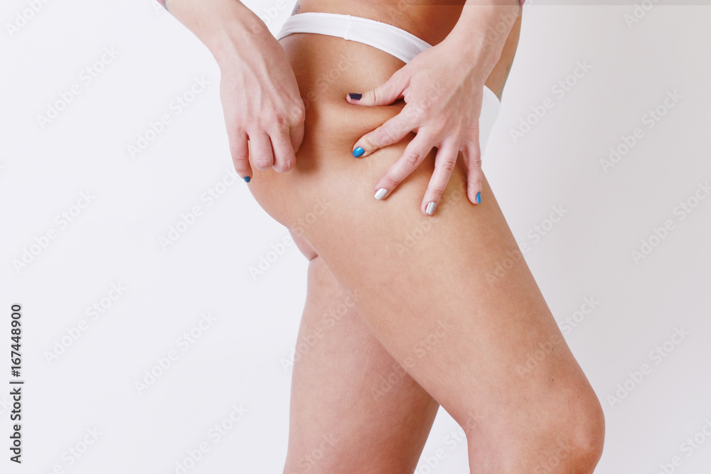 Cellulite fat removal skin. Young woman watches the weight