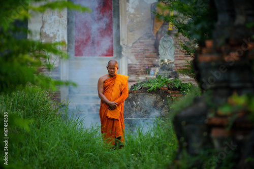 Buddhist monks are walking on temple in mist sunset,Thailand © saravut
