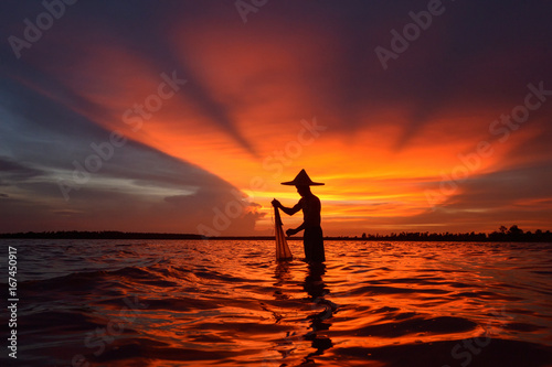 The silluate fisherman and nets  in river  on during sunset,Thailand © saravut