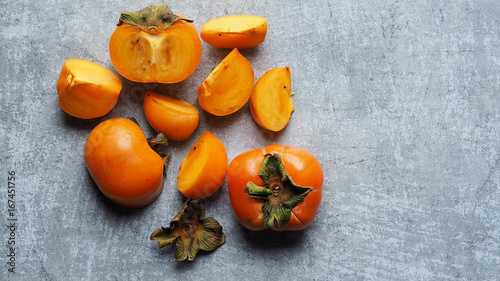 Ripe persimmon fruit on rustic table, tropical fruit photo