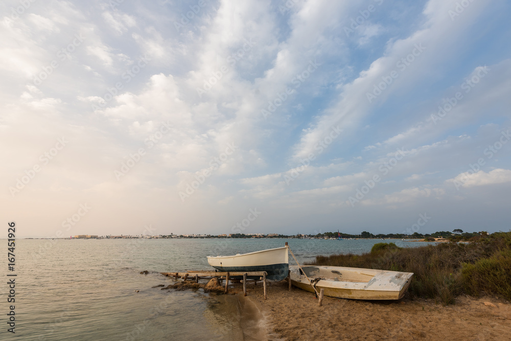 Panorama of a boat moored on the shore of the island of Formentera in Spain