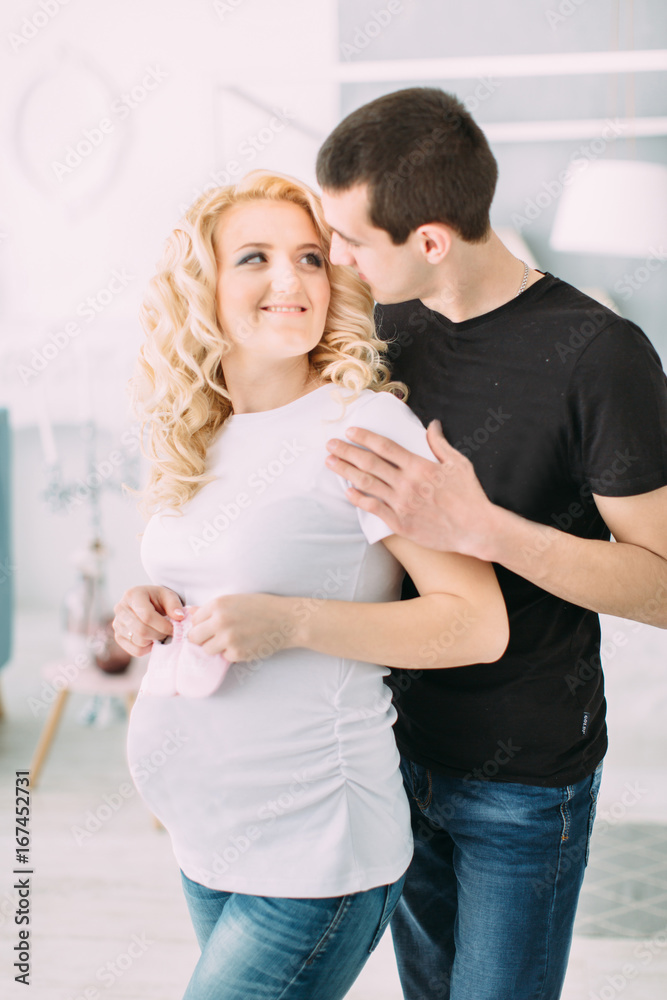 Pregnant girl with her husband smiling Pregnant girl with her husband smiling