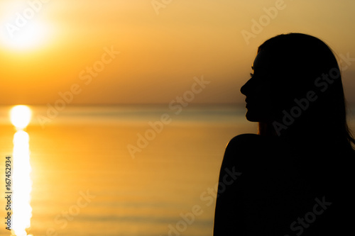 Gorgeous sunset on the water, perfect nature and beautiful scenery on vacation. Woman on vacation, sunset background 