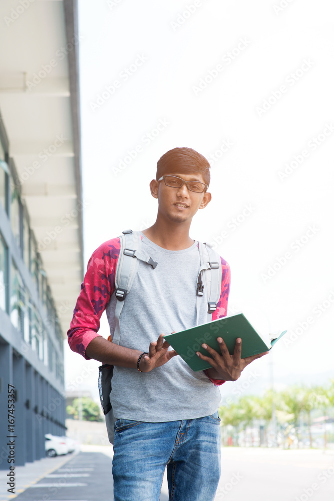 portrait of male indian high school student with schoolbag