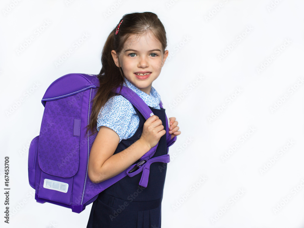 Cute smiling schoolgirl in uniform with school bag isolated on white background, 1 september