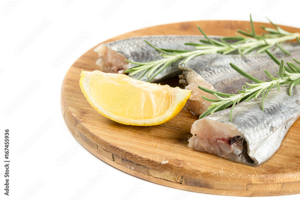 Fresh raw hake fish with lemon and rosemary branches Fresh raw hake fish with lemon and rosemary branches