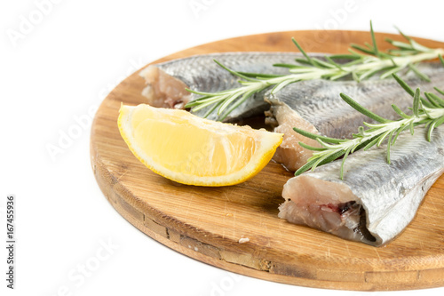 Fresh raw hake fish with lemon and rosemary branches