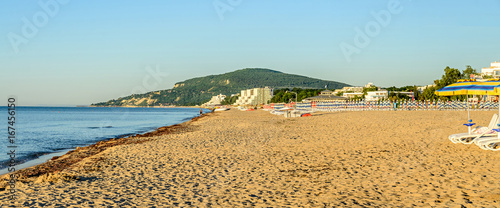 The Black Sea shore from Albena, Bulgaria with golden sands, blue fresh water, sunbeds and umbrellas near beach hotels