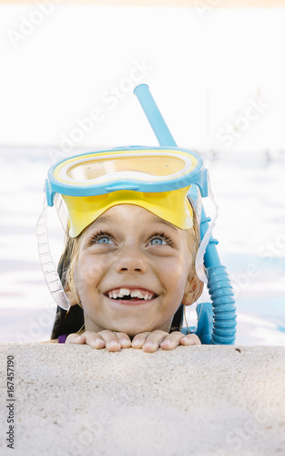 Kid in snorkel mask posing on poolside