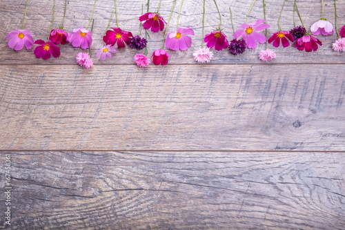 Pink and purple flowers cosmea or cosmos and cornflowers on rustic wooden boards. Copy space. Mother's, Valentines, Women's, Wedding Day concept