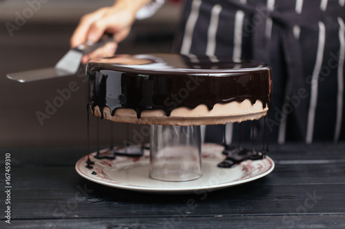 Glazing chocolate mousse cake, close-up