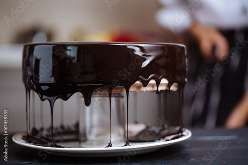 Glazing chocolate mousse cake, close-up