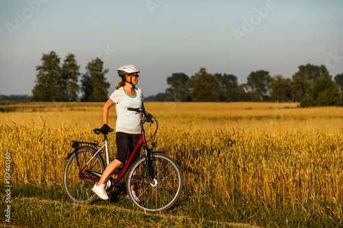Woman riding bicycle in countryside