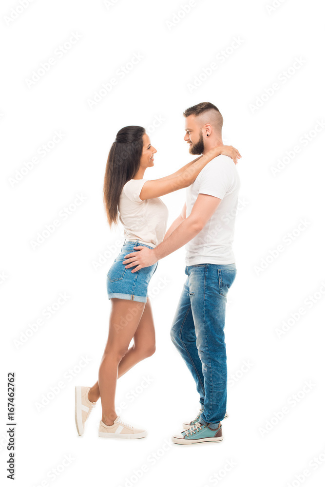 'portrait of young attractive couple standing face to face hugging each other, isolated on white