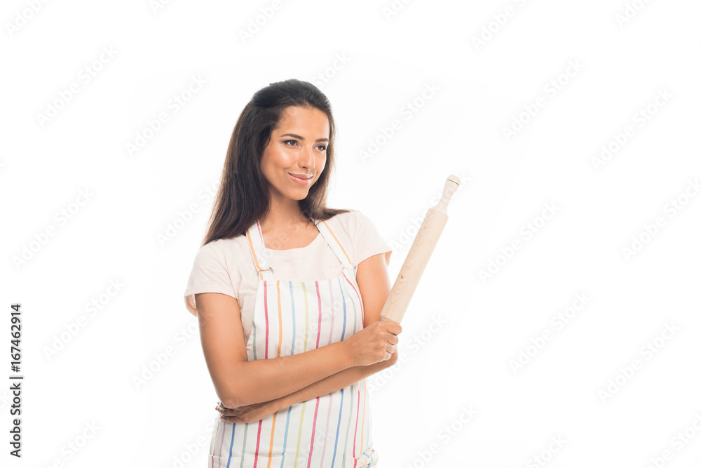 'Young housewife in apron, standing with rolling pin, isolated on white 'Young housewife in apron, standing with rolling pin, isolated on white