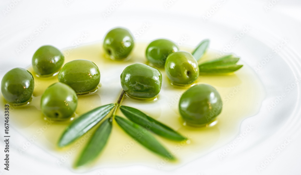 Plate with olives, olive oil, twig, olive branch Plate with olives, olive oil, twig, olive branch