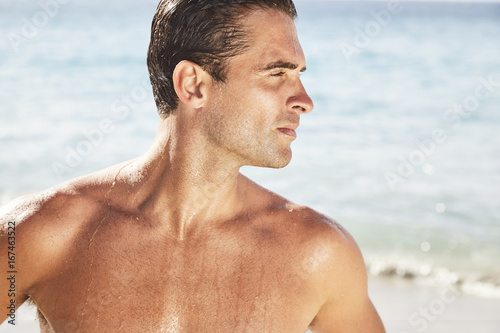 Handsome man on beach, looking away