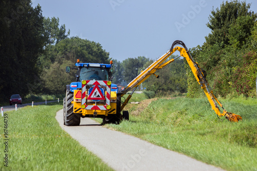 Tractor Mowing Roadside Shoulder photo