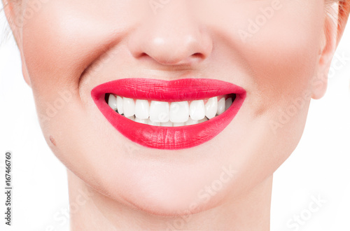White teeth and red lips. Perfect female smile after whitening teeth.