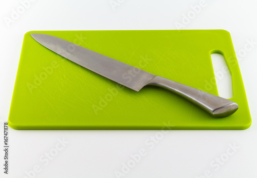 Kitchen Knife on Green Cutting Board Isolated on White Background