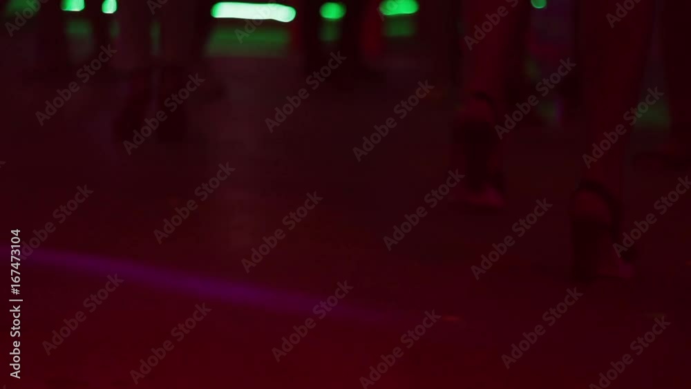 Beautiful female feet in shoes on heels move to music in a nightclub. Beautiful female feet in shoes on heels move to music in a nightclub.