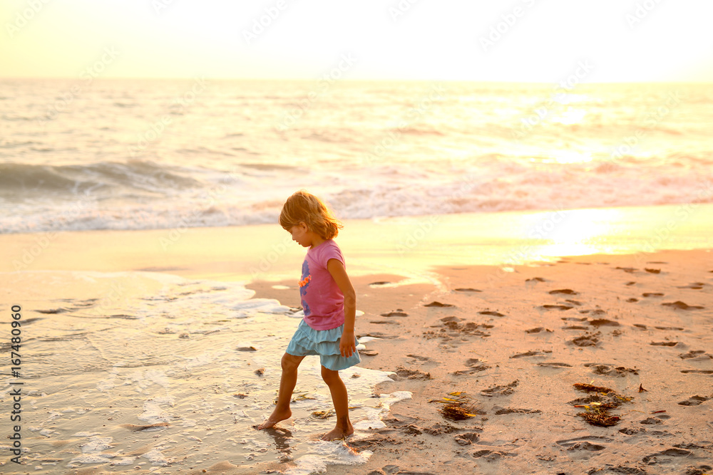 Young girl walking on the beach