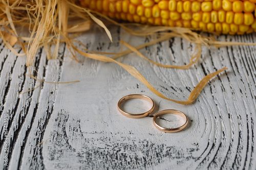 Wedding rings on white wiiden background. Concept of rustic wedding photo