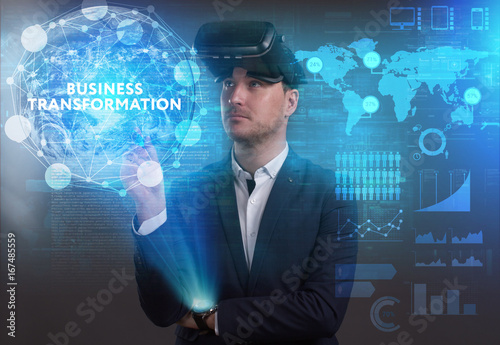 Business  Technology  Internet and network concept. Young businessman working on a virtual screen of the future and sees the inscription  Business transformation