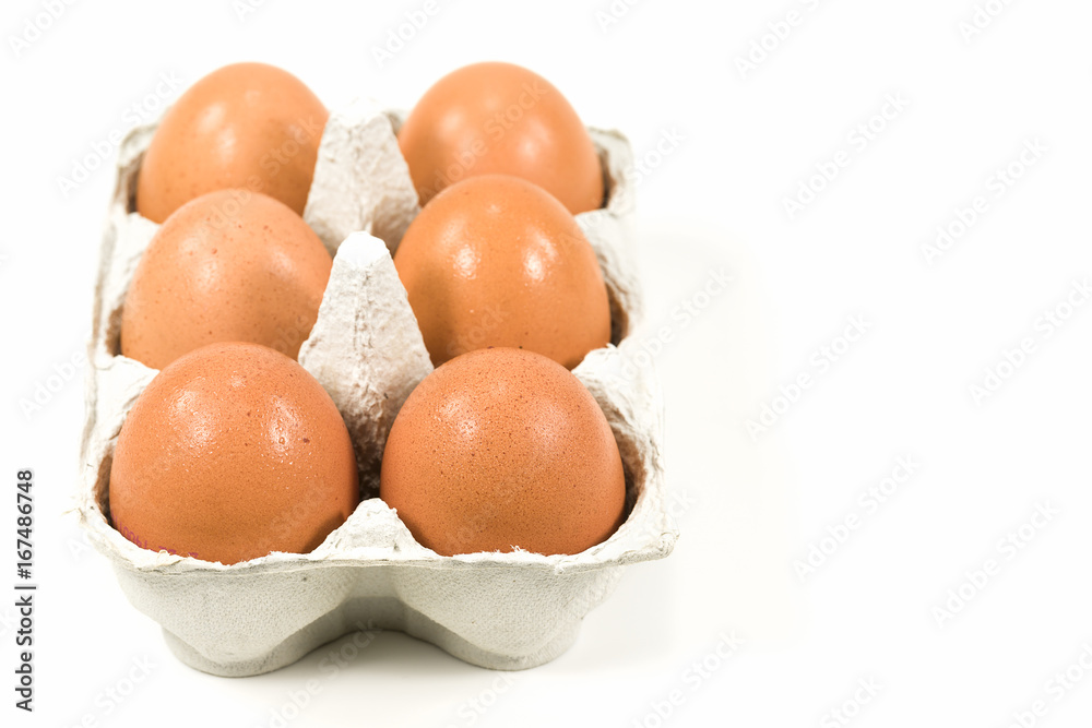 cardboard egg box with brown eggs isolated on white background cardboard egg box with brown eggs isolated on white background