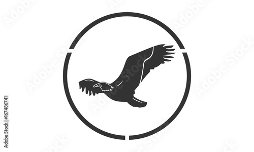 the eagle silhouette logo flies over the sea