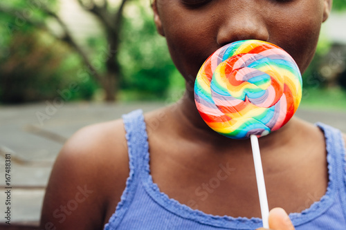 African American girl with rainbow lollipop photo