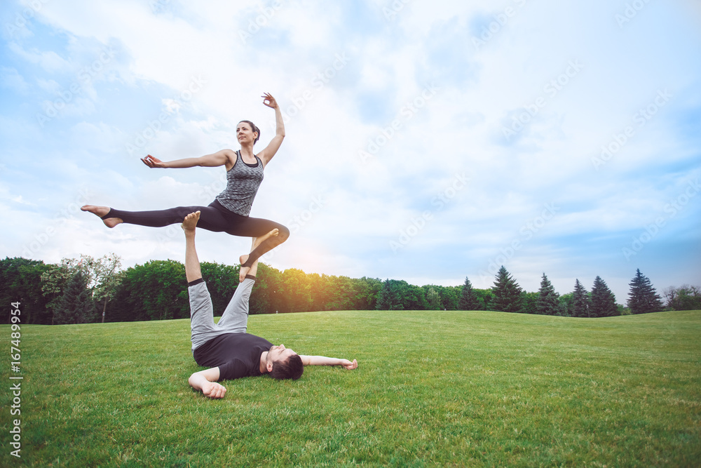 People practice acro yoga outdoors healthy lifestyle People practice acro yoga outdoors healthy lifestyle