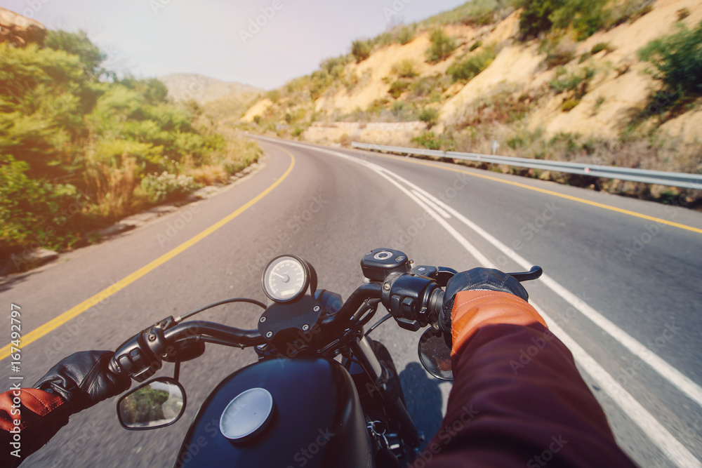 The Road view over the handlebars of motorcycle The Road view over the handlebars of motorcycle
