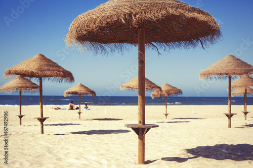 Beach umbrella on sunny day with sea background