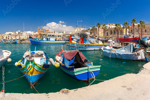 Traditional eyed colorful boats Luzzu in the Harbor of Mediterranean fishing village Marsaxlokk  Malta