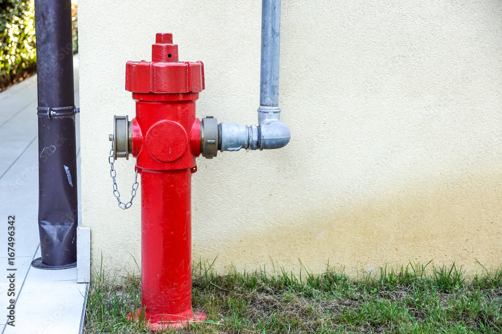 Old red fire hydrant in the street. Fire hidrant for emergency fire access Old red fire hydrant in the street. Fire hidrant for emergency fire access