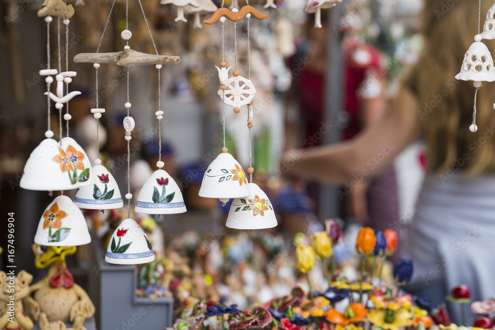 Ceramic bells as a souvenir in local traditional market. - obrazy, fototapety, plakaty 