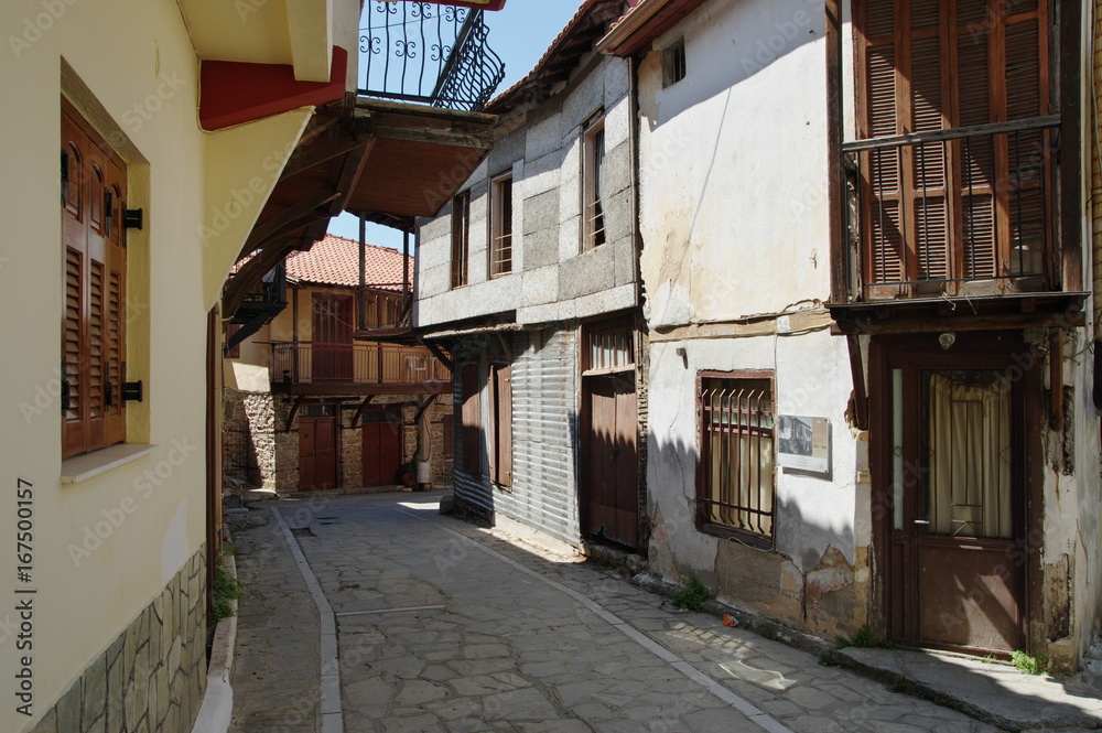Arnea, small town near the Chalkidiki peninsula in northen Greece. Region of Macedonia. Street in the city center. Along the road are houses with typical architecture of the region.