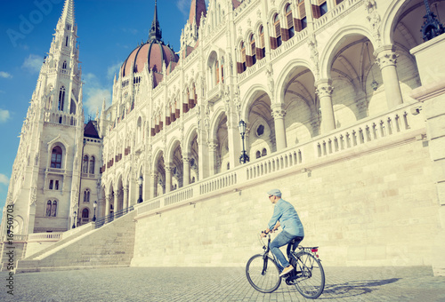 Young man riding bicycle in Budapest, Hungary