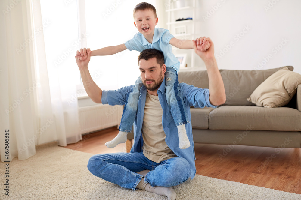 father with son playing and having fun at home
