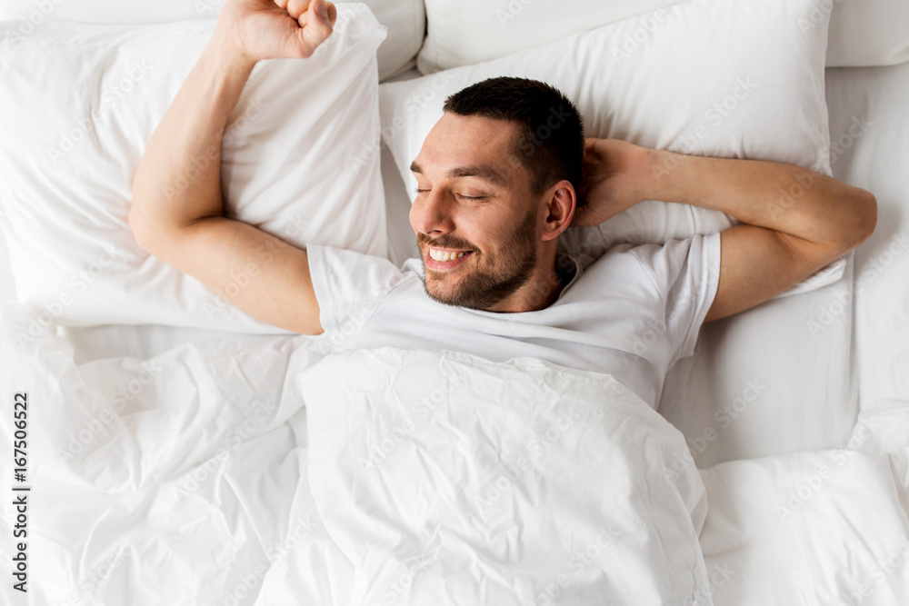man lying in bed at home man lying in bed at home