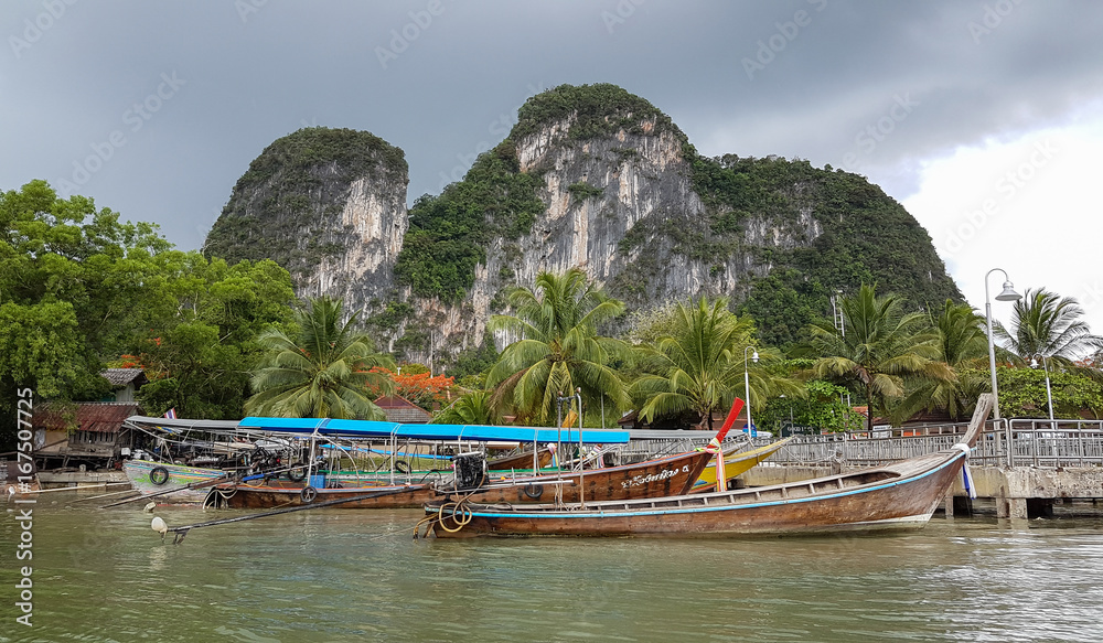 Phang Nga Bay, Thailand - May 15th 2017: Traditional Thai longboats in Phang Nga Bay