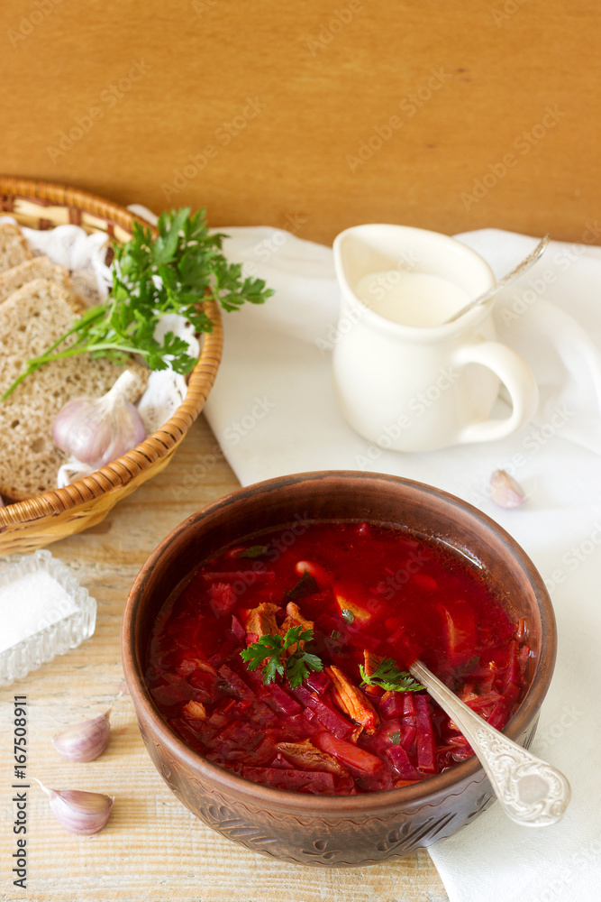 A traditional dish of Russian and Ukrainian cuisine - borsch. Soup with beets, meat, potatoes and beans. Served with sour cream and garlic. A traditional dish of Russian and Ukrainian cuisine - borsch. Soup with beets, meat, potatoes and beans. Served with sour cream and garlic.