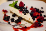 Berry cheesecake with berries on a plate in a caffe
