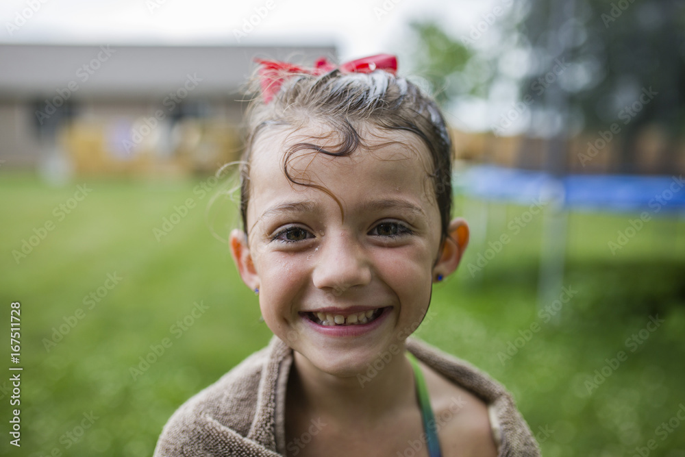 Portrait of happy girl wrapped in towel at yard Portrait of happy girl wrapped in towel at yard