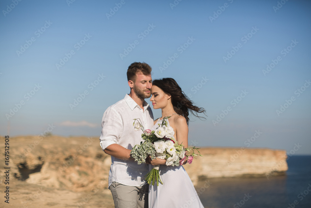 Beautiful young couple on a date. The guy hugging and kissing a girl. Beautiful young couple on a date. The guy hugging and kissing a girl.