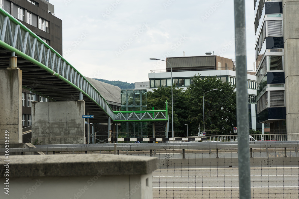 bridge on street with cars passing by bridge on street with cars passing by